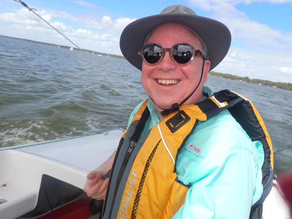 David sailing a boat wearing sunglasses